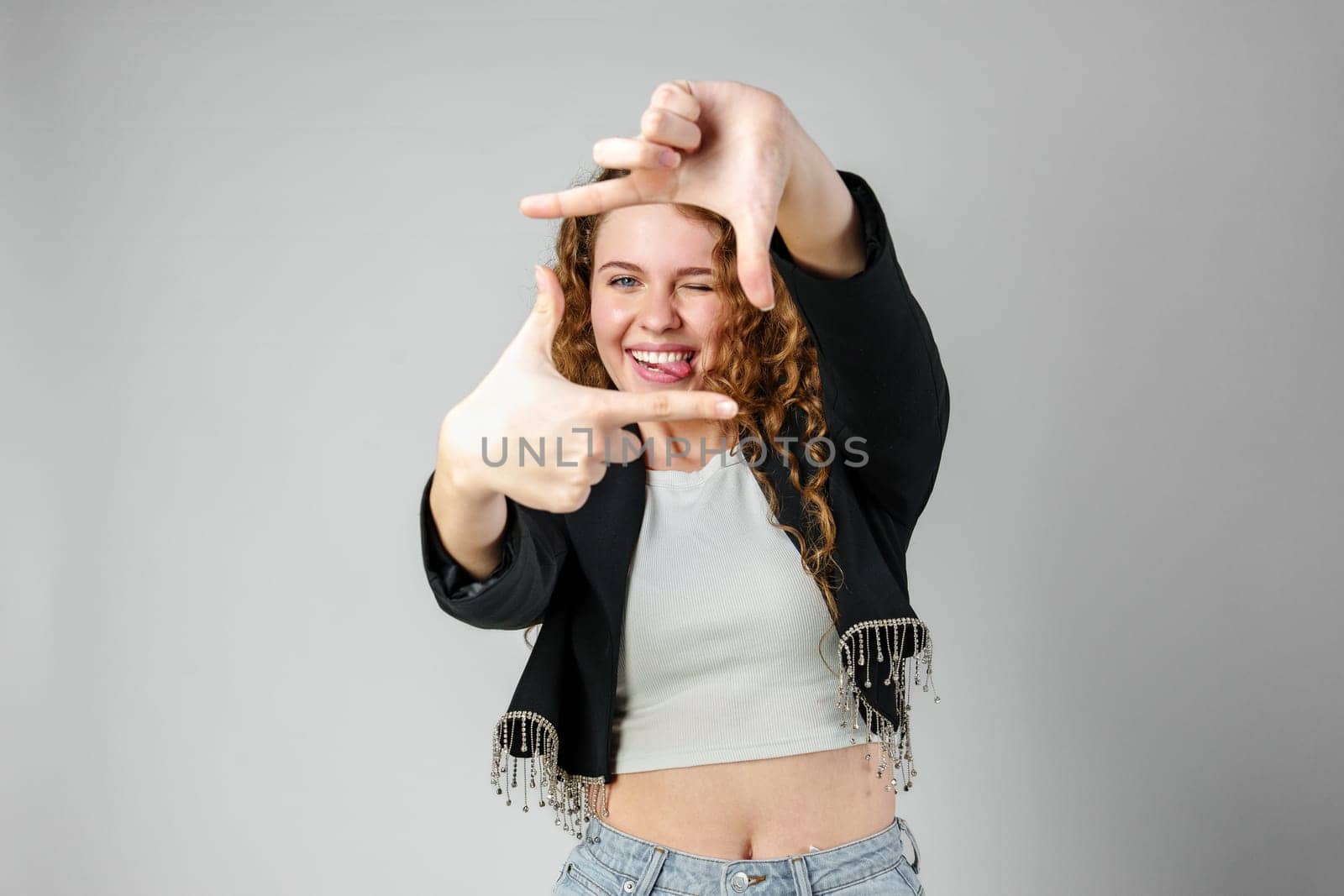 Woman Making Hand Gesture Picture Frame in Studio close up