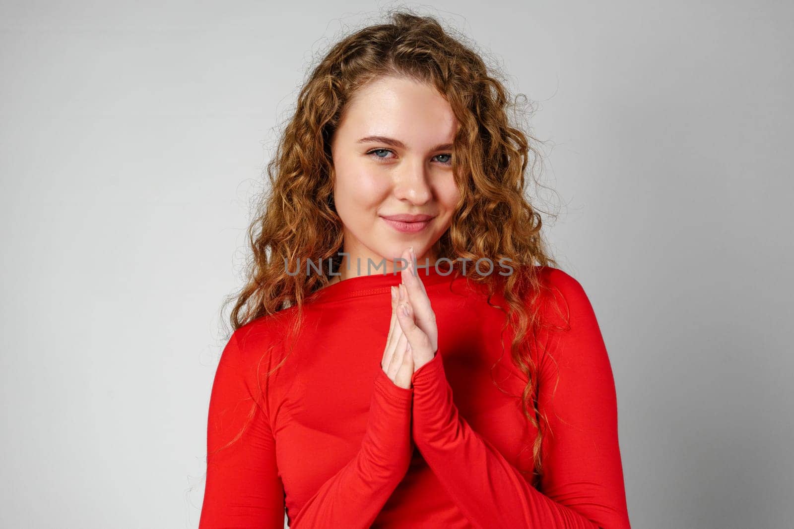 Young Woman With Curly Hair Portrait against gray background in studio