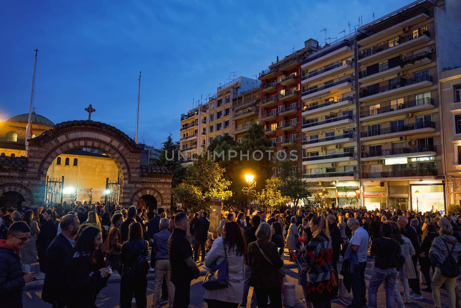 Thessaloniki, Greece Gathered crowd outside a Christian Orthodox church on a Good Friday waiting to attend the commemoration of decorated with flowers Epitafios.