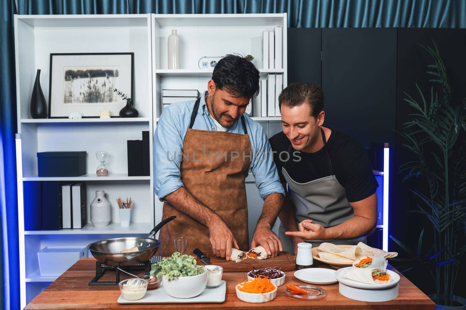 Healthy influencers presenting fresh salad roll power on cooking show, displaying ingredients of diversity vegetables and homemade soft tortilla wrap on table. Channel on social media live. Sellable.