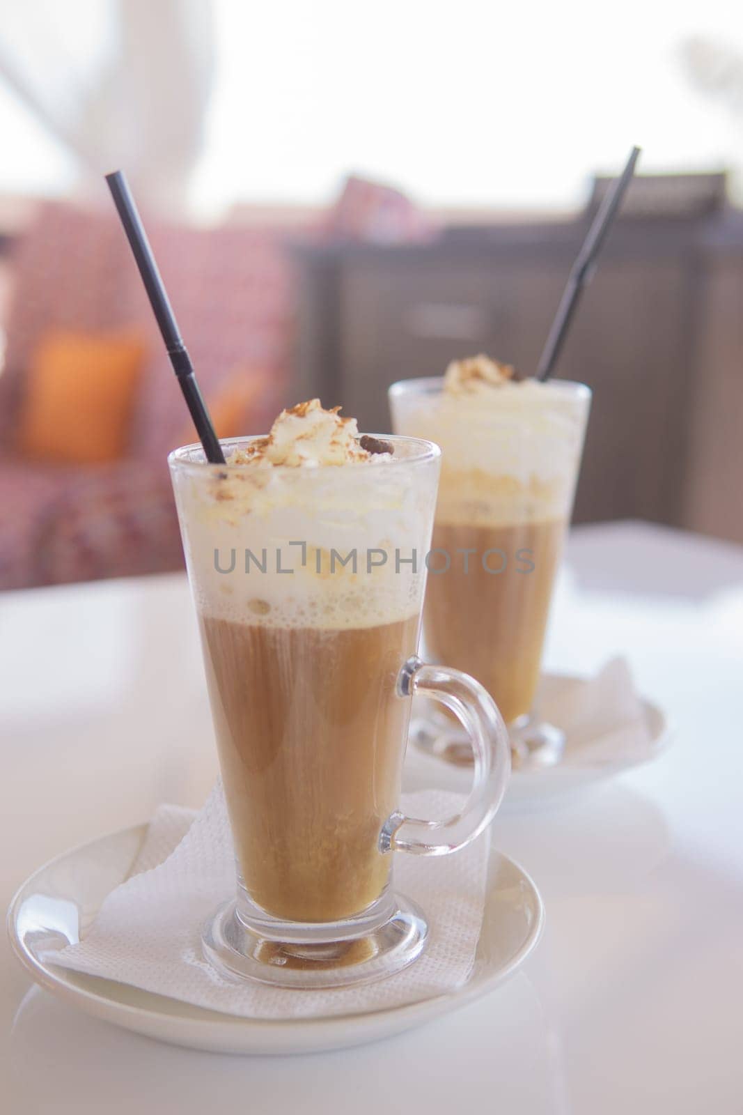coffee is served in a tall glass glass with a straw. The concept of coffee drinks from the bar menu by Annu1tochka
