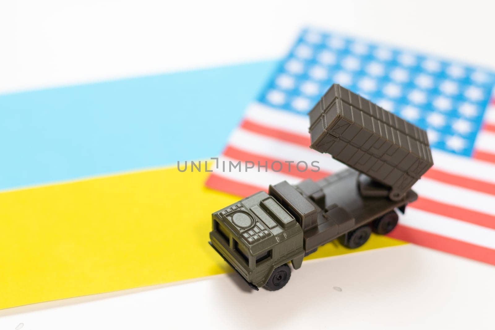 military vehicle and flags of the USA and Ukraine. Defeat of Russia in war in Ukraine concept. High quality photo