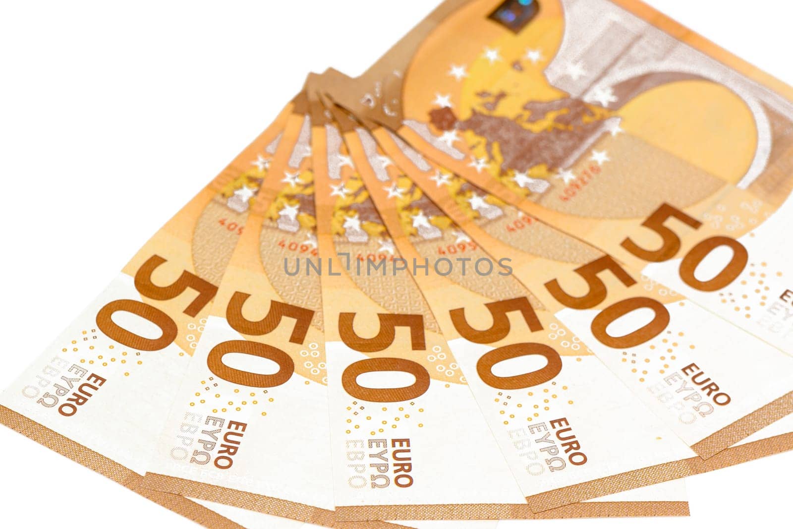 Concept of many euros: a pile of 50-euro bills lying on a white background. Many 50 € bills isolated on white background.