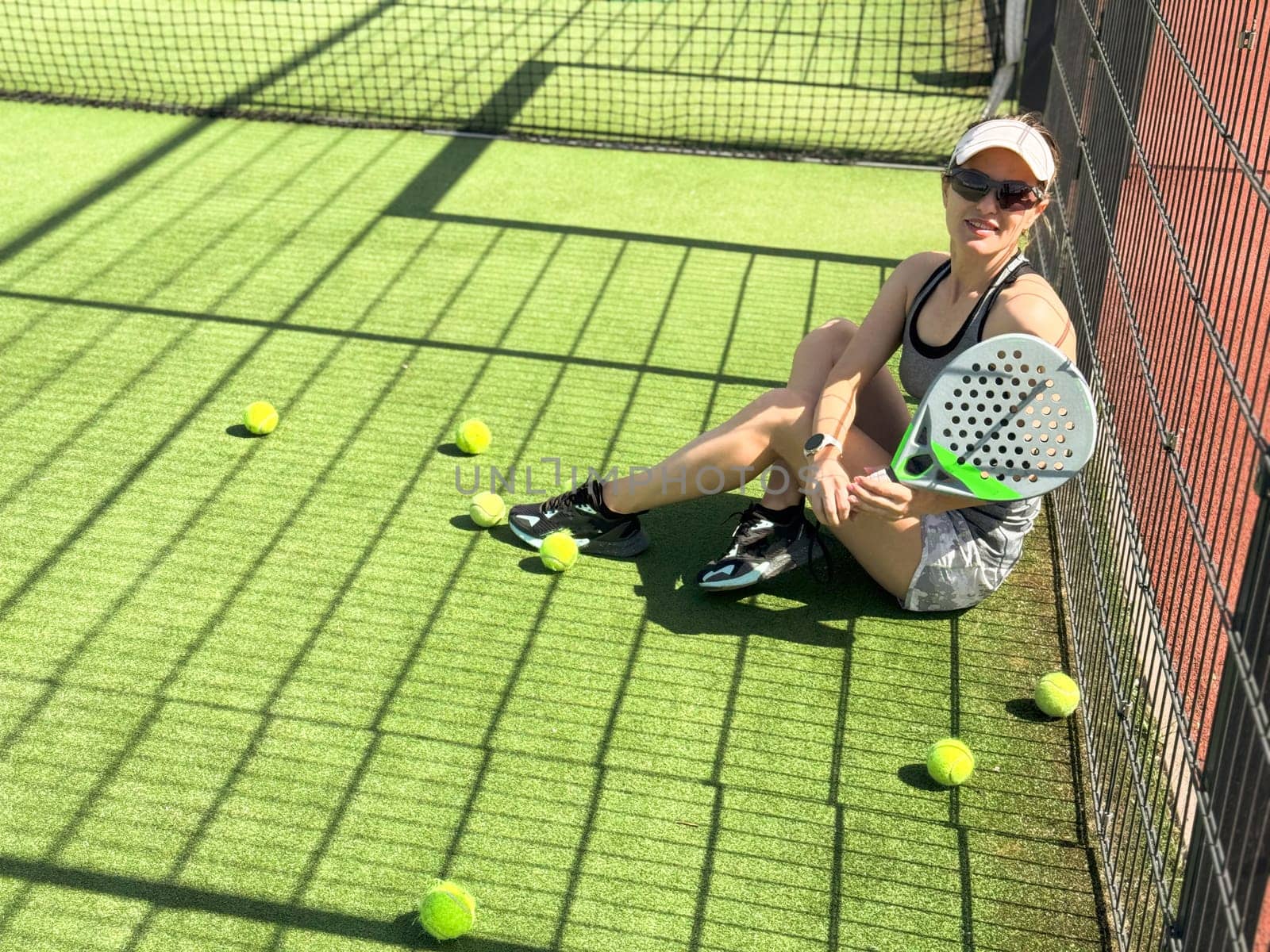 Woman players serving ball. Young adult girl play tennis outside arena. Person racket beat game club. People group hit sport court match. Fit care free time. Run skill train. Padel tennis team workout by Andelov13