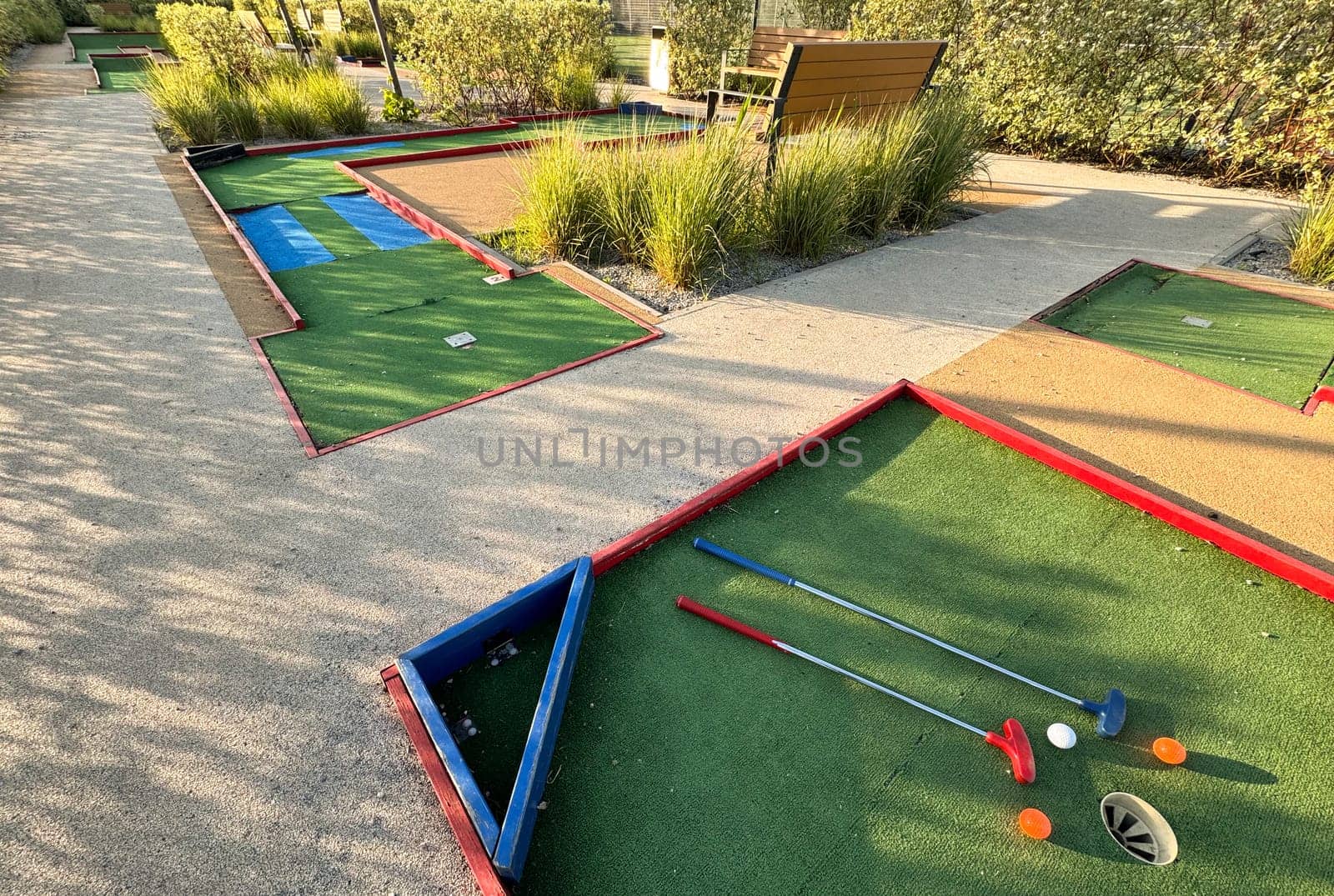 colorful golf putters with golf balls on synthetic grass. High quality photo