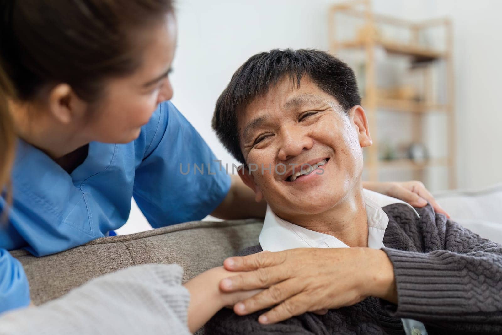 elderly touch hand on back of hand caregiver or nurses to express thankful.