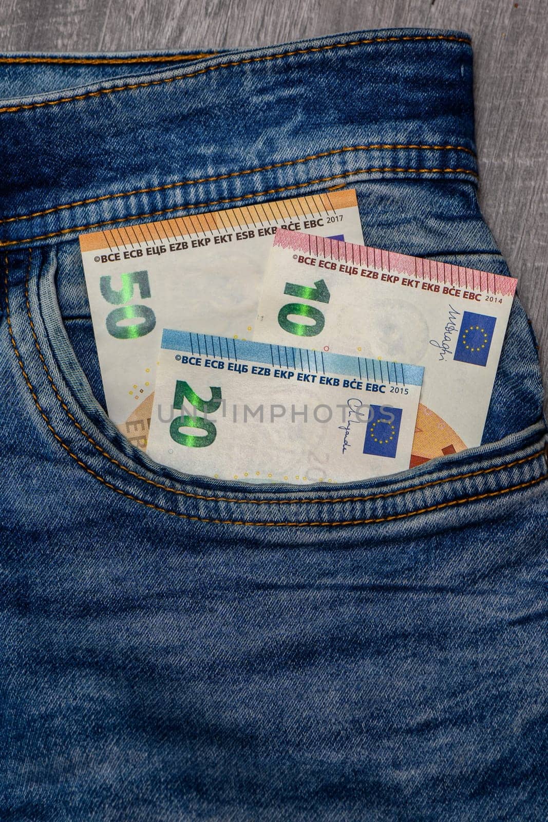 Euro bank notes in a demin jeans pocket by Mixa74