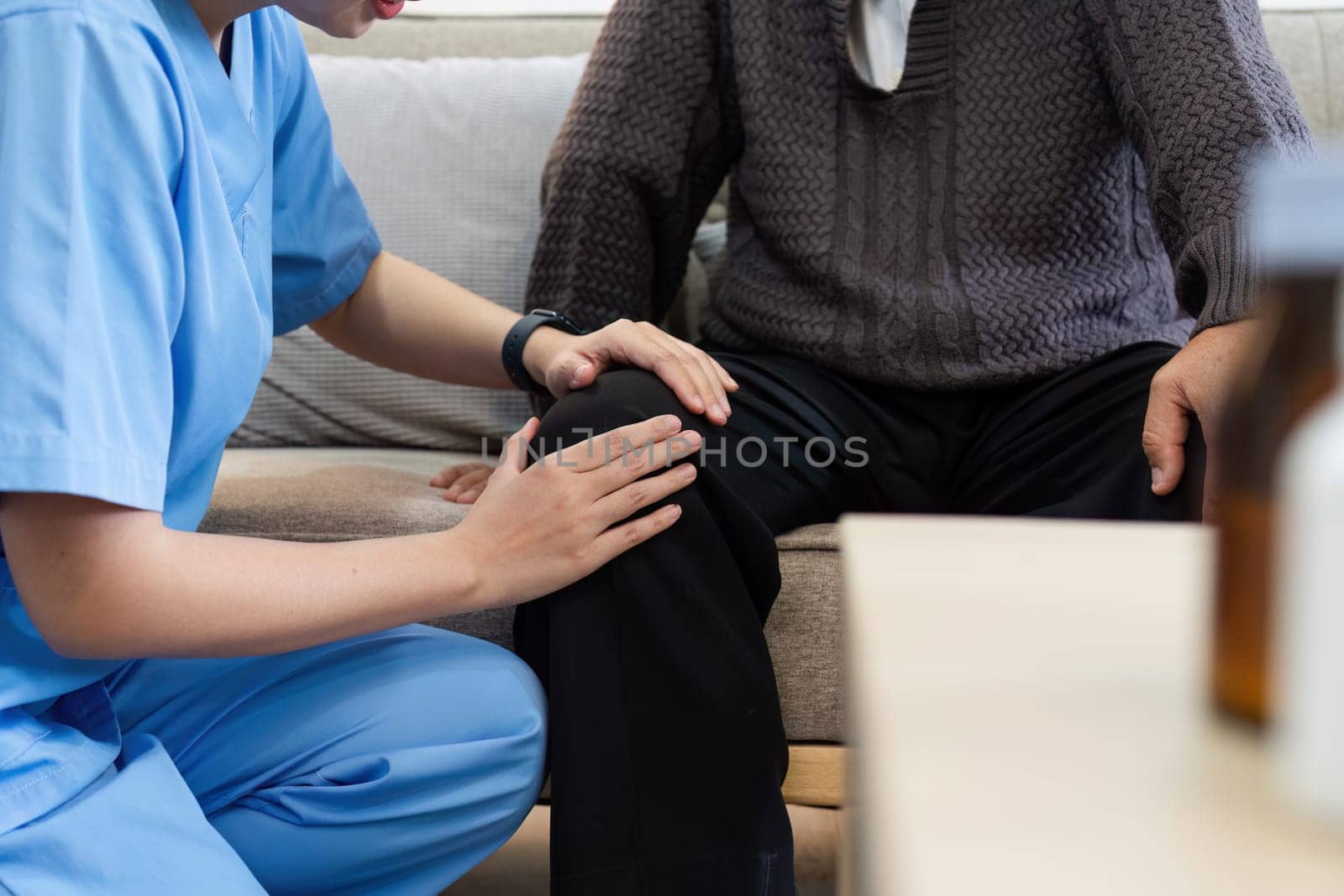 physiotherapist doctor or caregiver helping senior elderly man stretching his hamstring.