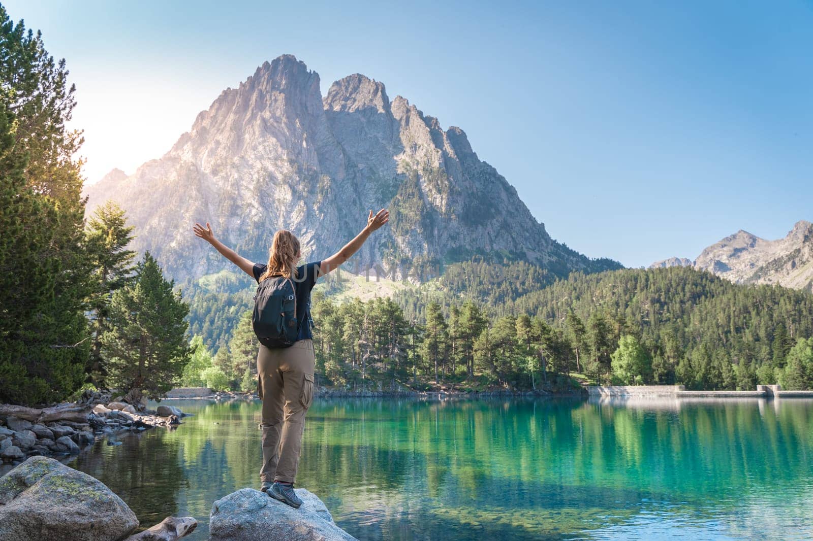 Woman With raised Arms in a majestic Lake in summer. Discovery Travel Destination. Freedom Concept by PaulCarr
