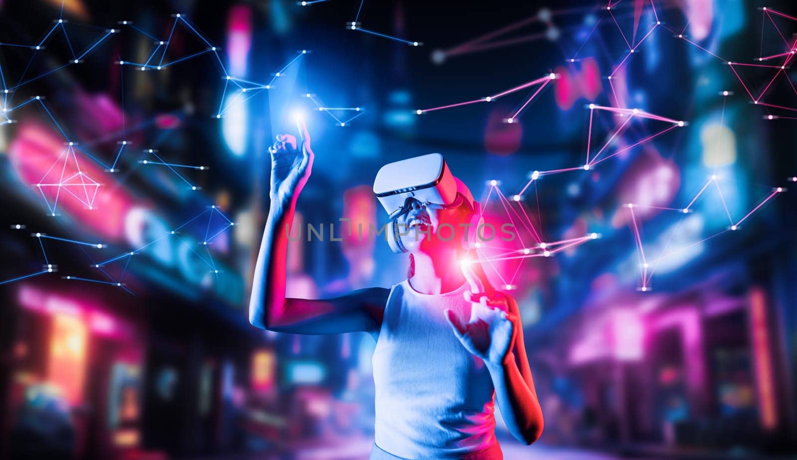 Female stand in cyberpunk style building in meta wear VR headset connect metaverse, future cyberspace community technology. Woman use fingers touch objects, light appear where she stab. Hallucination.