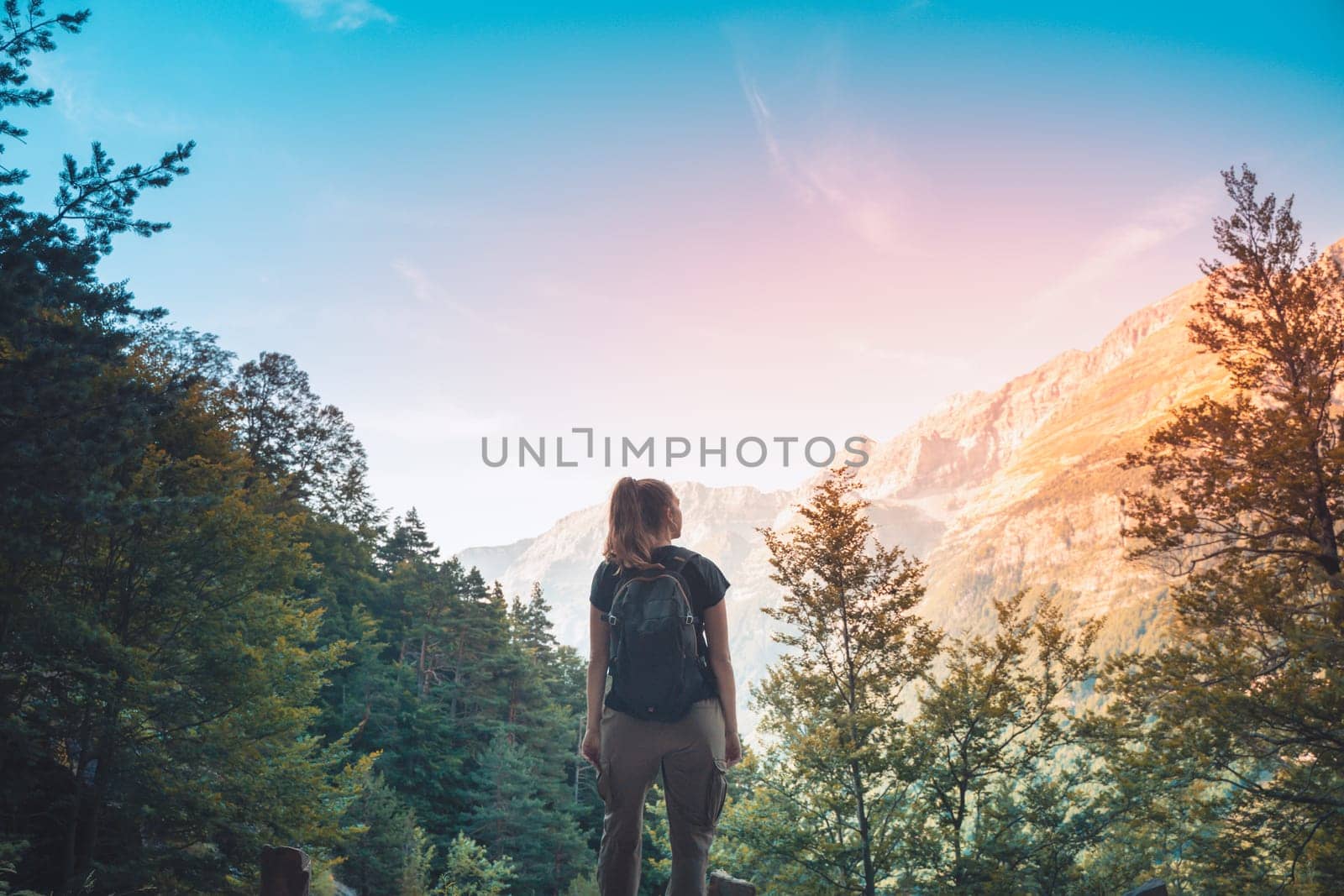 Woman majestic nature views in summer. Backpack hiking mountains. Freedom Concept. High quality photo