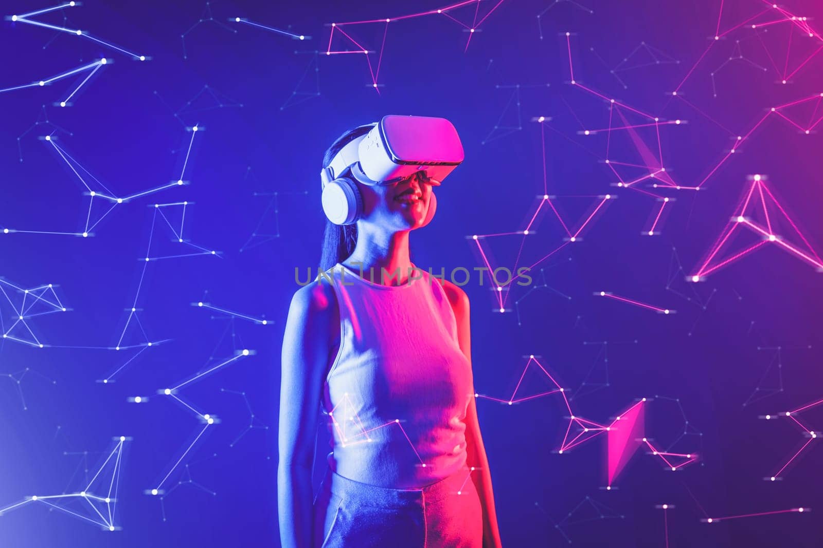 Female stand in cyberpunk neon light wear white VR headset and tank top connecting metaverse, future cyberspace community technology, She look in virtual reality object holding goggles. Hallucination.
