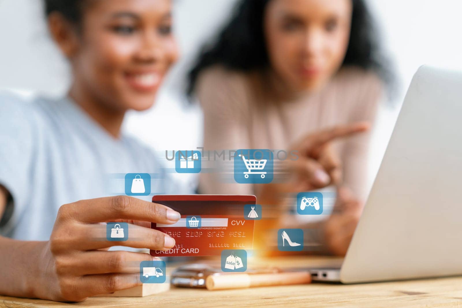 Elegant customers wear blue shirt holding credit card pointing laptop. Smart brown shirt user watching laptop while open e-commerce application using cashless technology shopping inventory. Cybercash.