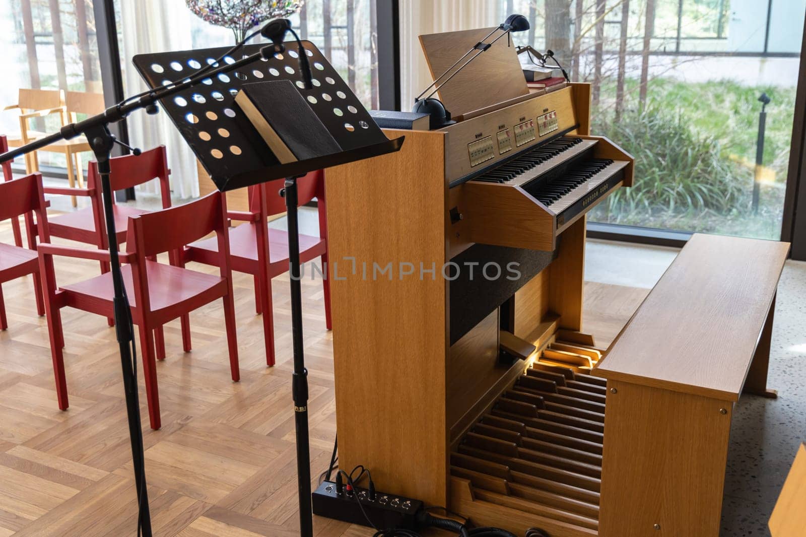 Small indoors pipe organ. Musical instrument for church singing and concerts.