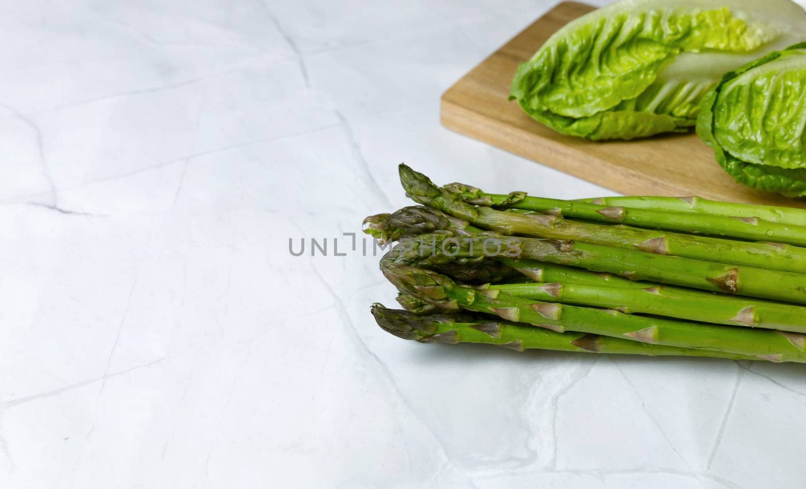 Fresh vegetables on the kitchen table cabbage, salad, asparagus. High quality photo