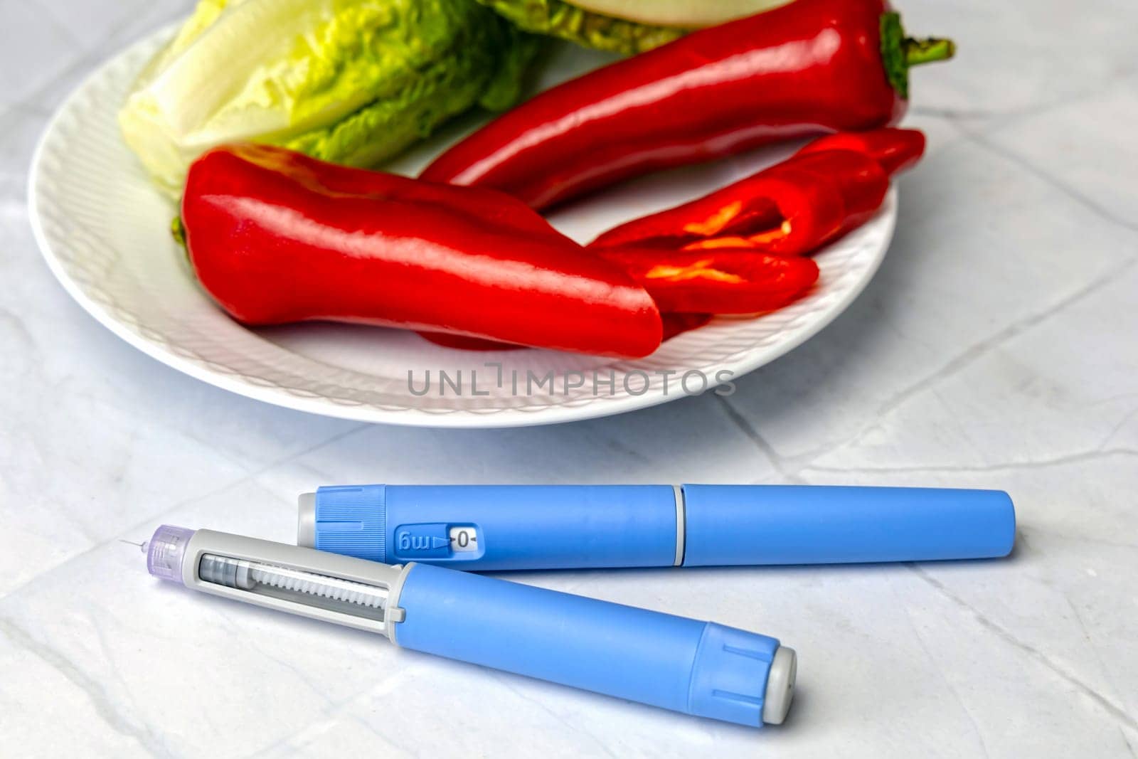 Original Danish Ozempic Insulin injection pen for diabetics and plate with vegetables. High quality photo