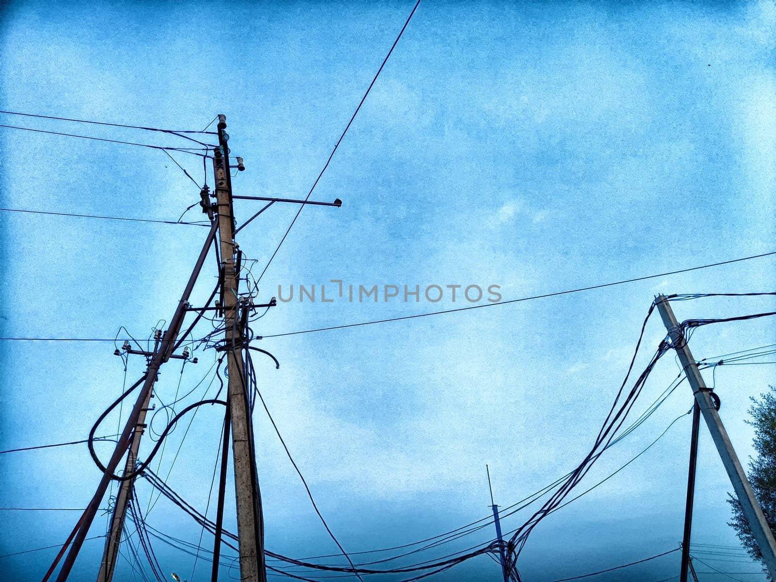 Old pole with wires against the sky. Electric transmission line. Eco-friendly energy by keleny