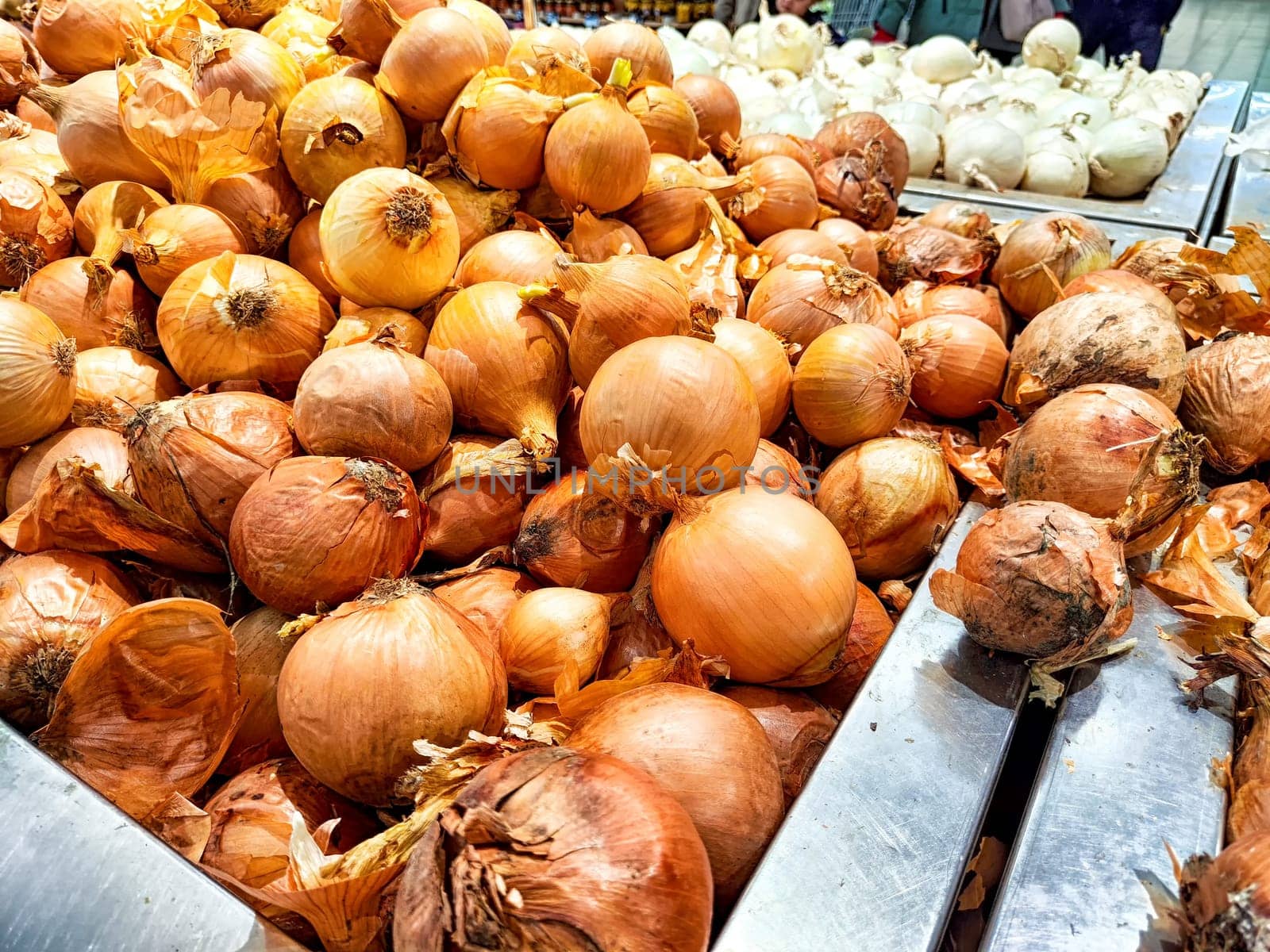 Fresh onions spread out for customers at a market. Pile of Fresh Onions for Sale at Local Market Stall