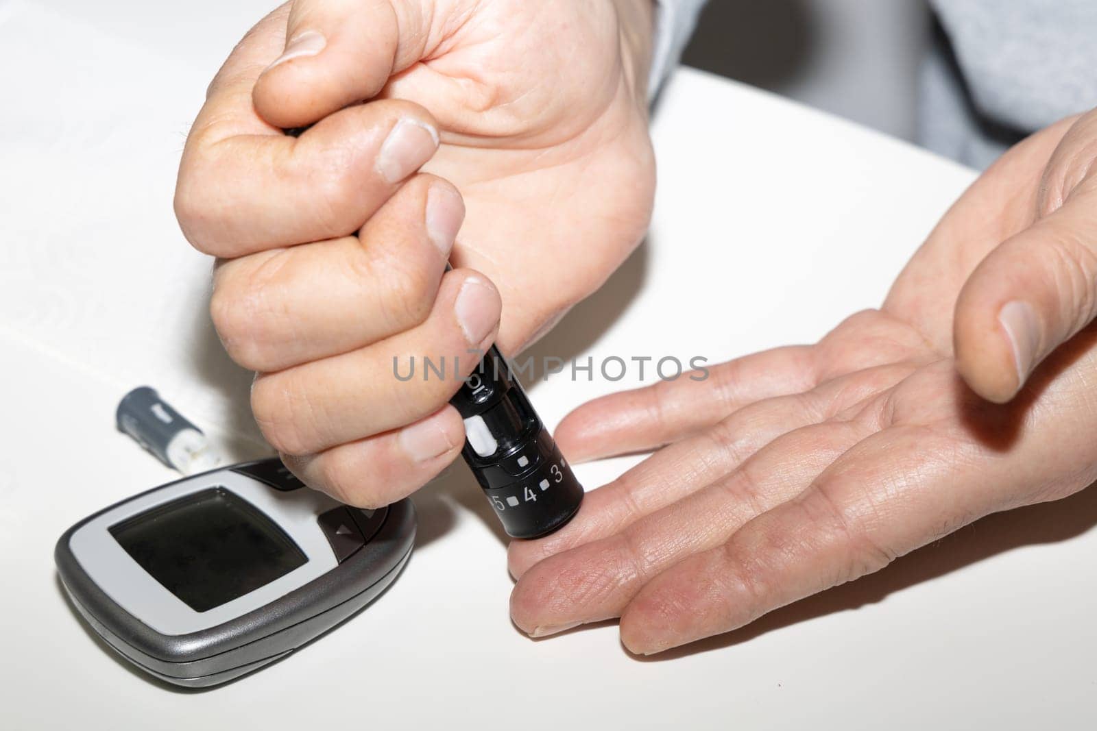 Diabetic man measuring blood sugar level. Blood test for diabetes. High quality photo