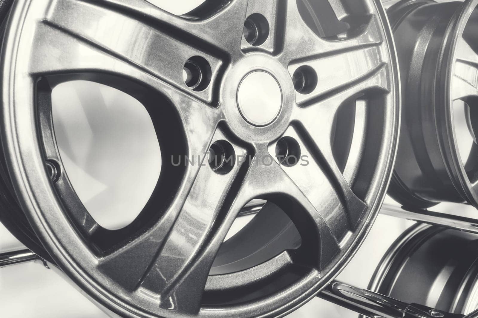 Close-up of alloy wheels for passenger cars on a store stand by Rom4ek