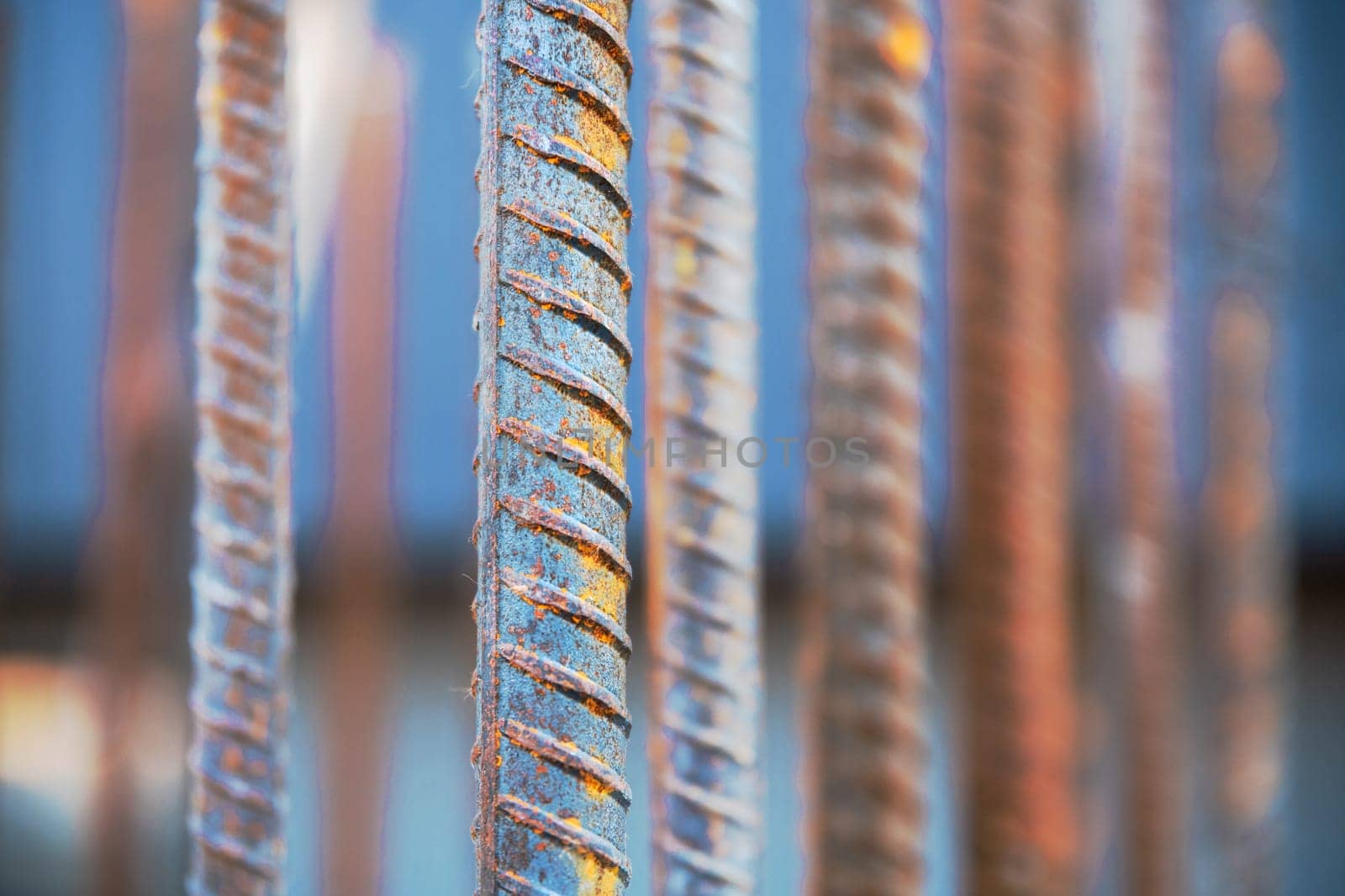 Steel bars or steel reinforcement bars are utilized at construction sites for reinforcing concrete, close-up and selective soft focus by Rom4ek