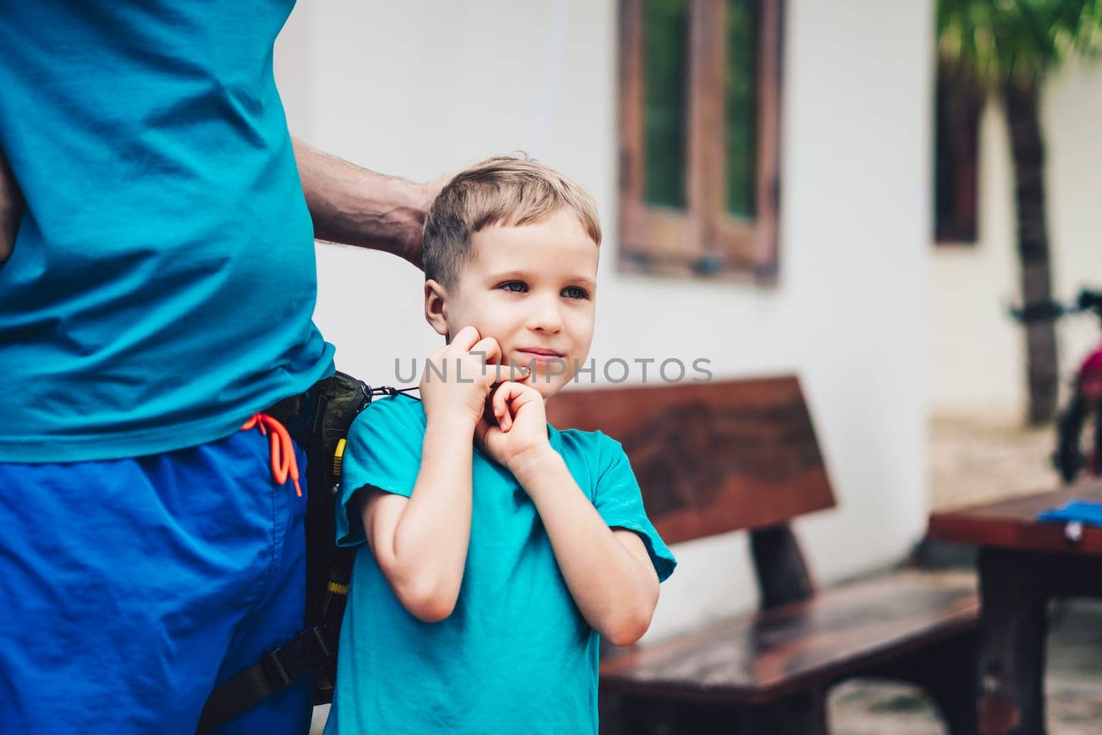 Closeup image of little son tender hugging his fathers hands. Happy childhood parenthood harmony.