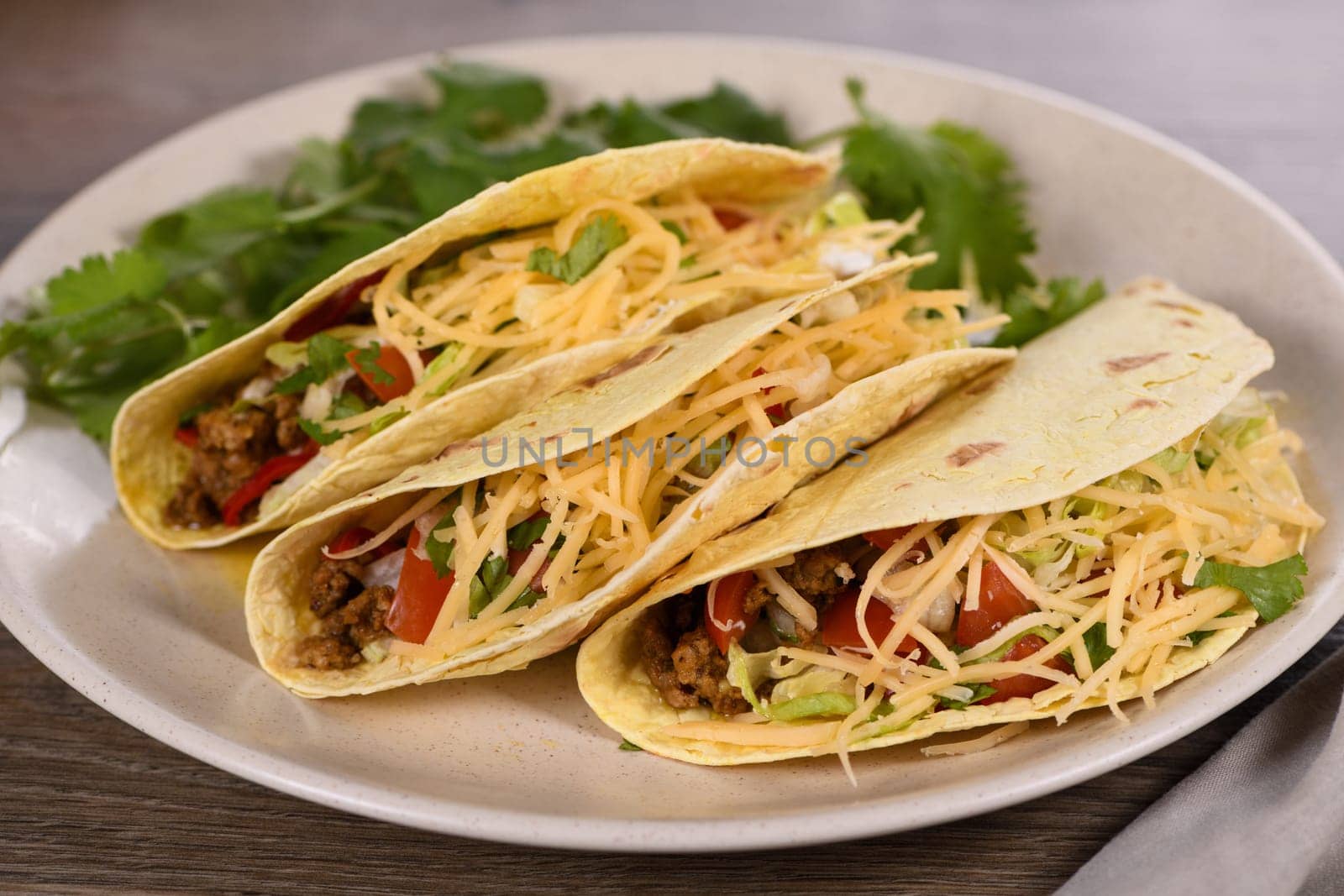 Taco with ground beef and avocado, cabbage and cheese. Mexican cuisine. 