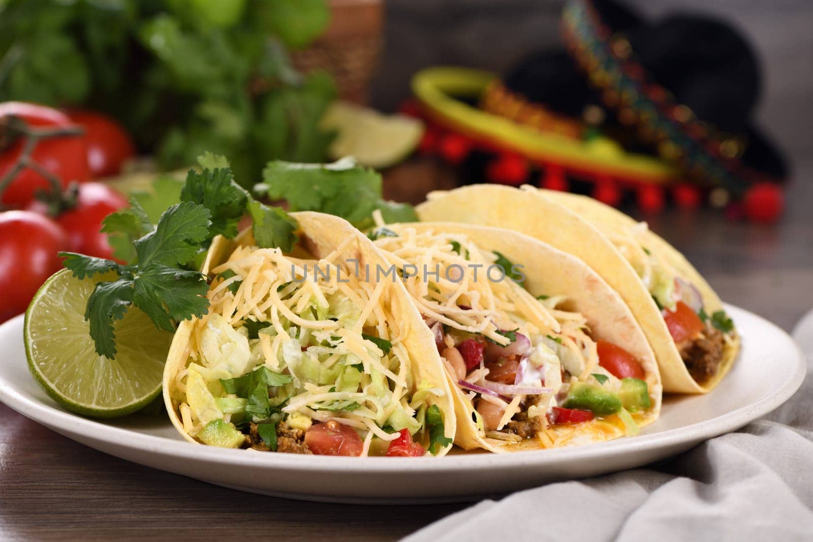 Taco with ground beef and avocado, cabbage and cheese. Mexican cuisine. Close-up.