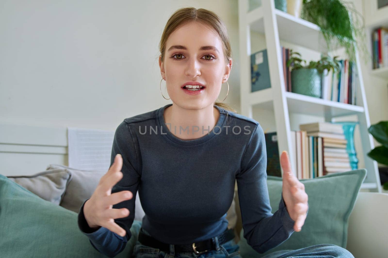 Web camera view of teenage girl 16,17,18 years old talking looking in camera, online meeting, internet video call chat conference. Attractive teenager female blogger vlogger recording video in home