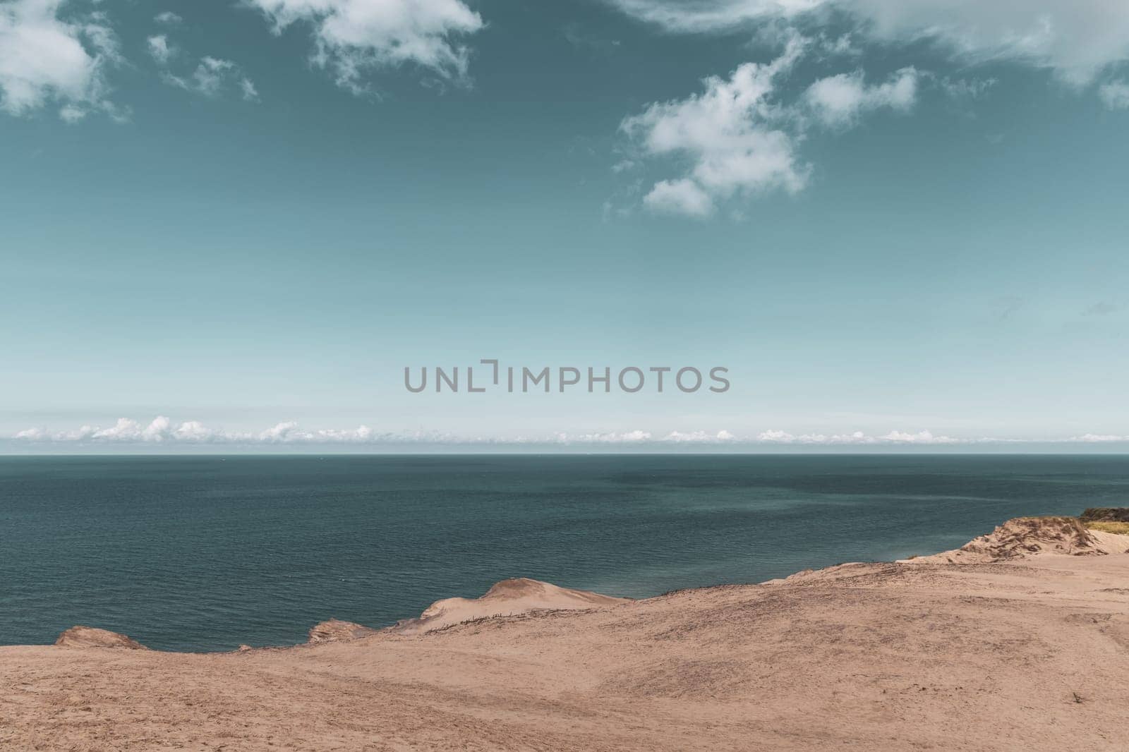 Sand dunes and seascape next to Rubjerg Knude Lighthouse, Denmark.