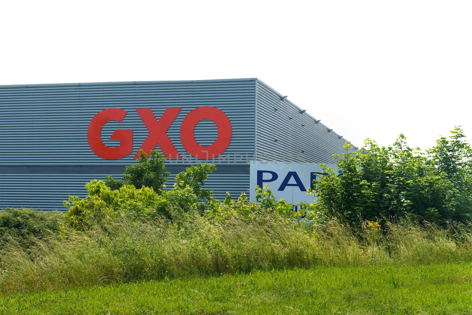 GXO Logistics Warehouse Exterior View On A Sunny Day With Clear Skies by Sd28DimoN_1976