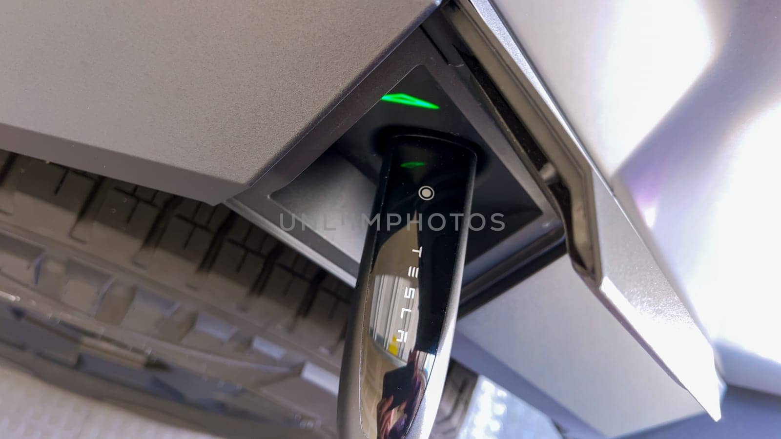 Charging a Tesla Cybertruck: Detailed View of the Connector and Port by arinahabich