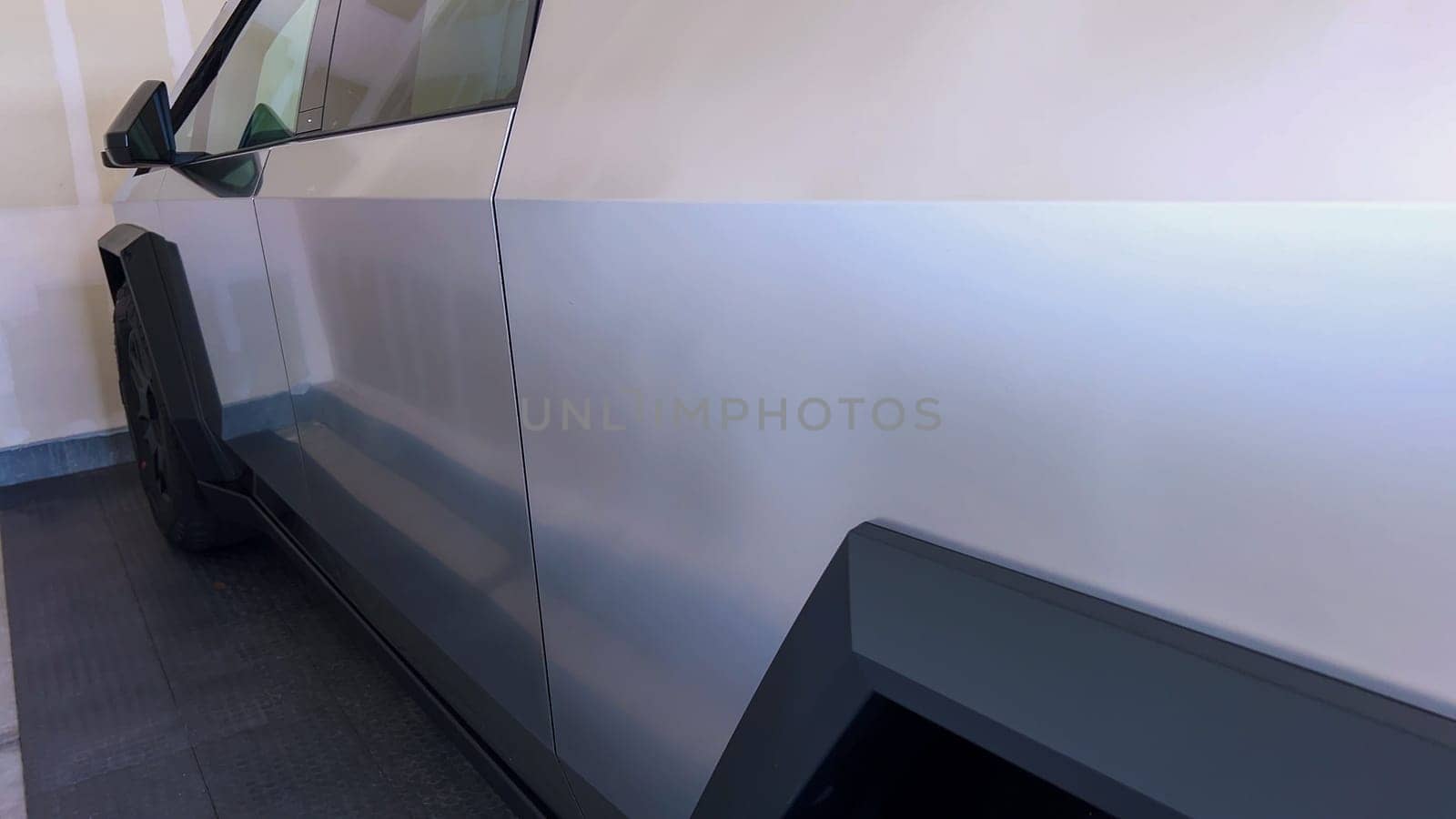 A close-up image emphasizing the sharp, angular design and textured metallic surface of the Tesla Cybertruck, showcasing the attention to detail in its robust and innovative construction.