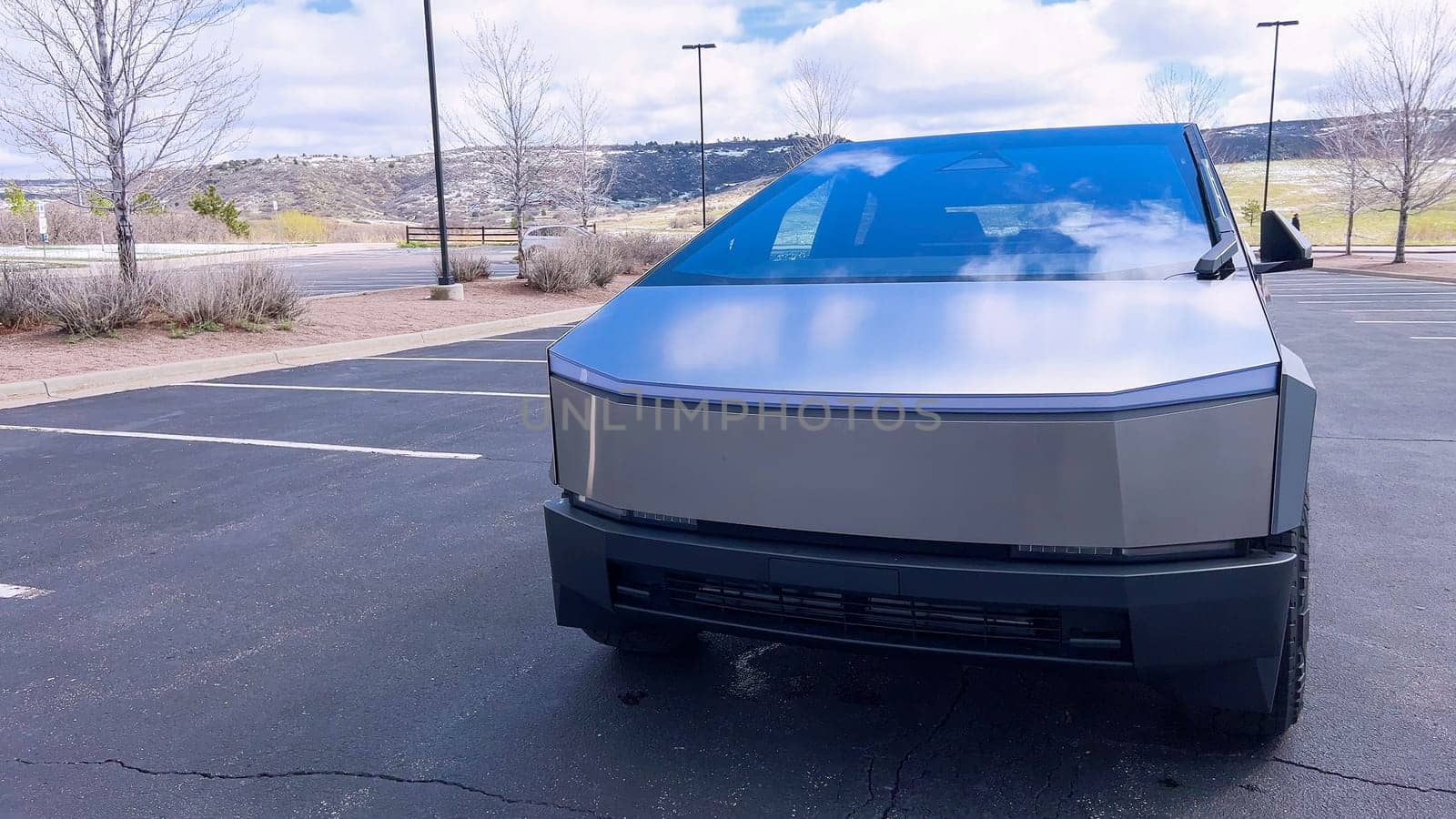 Front View of a Tesla Cybertruck in an Outdoor Parking Lot by arinahabich