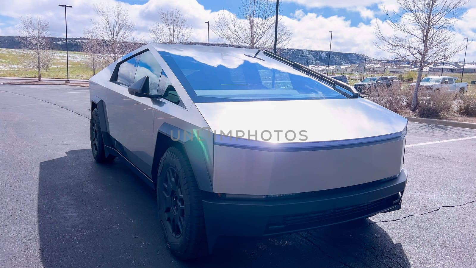 Front View of a Tesla Cybertruck in an Outdoor Parking Lot by arinahabich