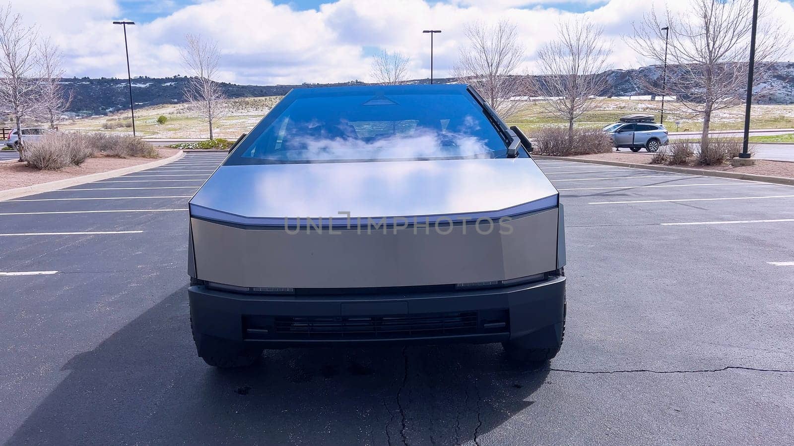 Front View of a Tesla Cybertruck in an Outdoor Parking Lot by arinahabich