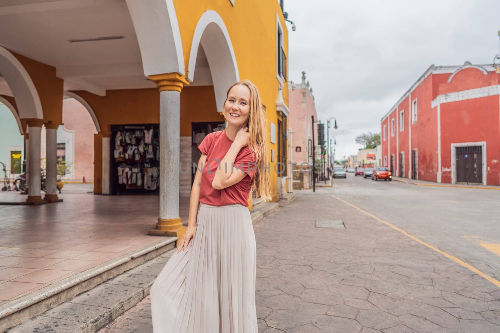 Woman tourist explores the vibrant streets of Valladolid, Mexico, immersing herself in the rich culture and colorful architecture of this charming colonial town by galitskaya