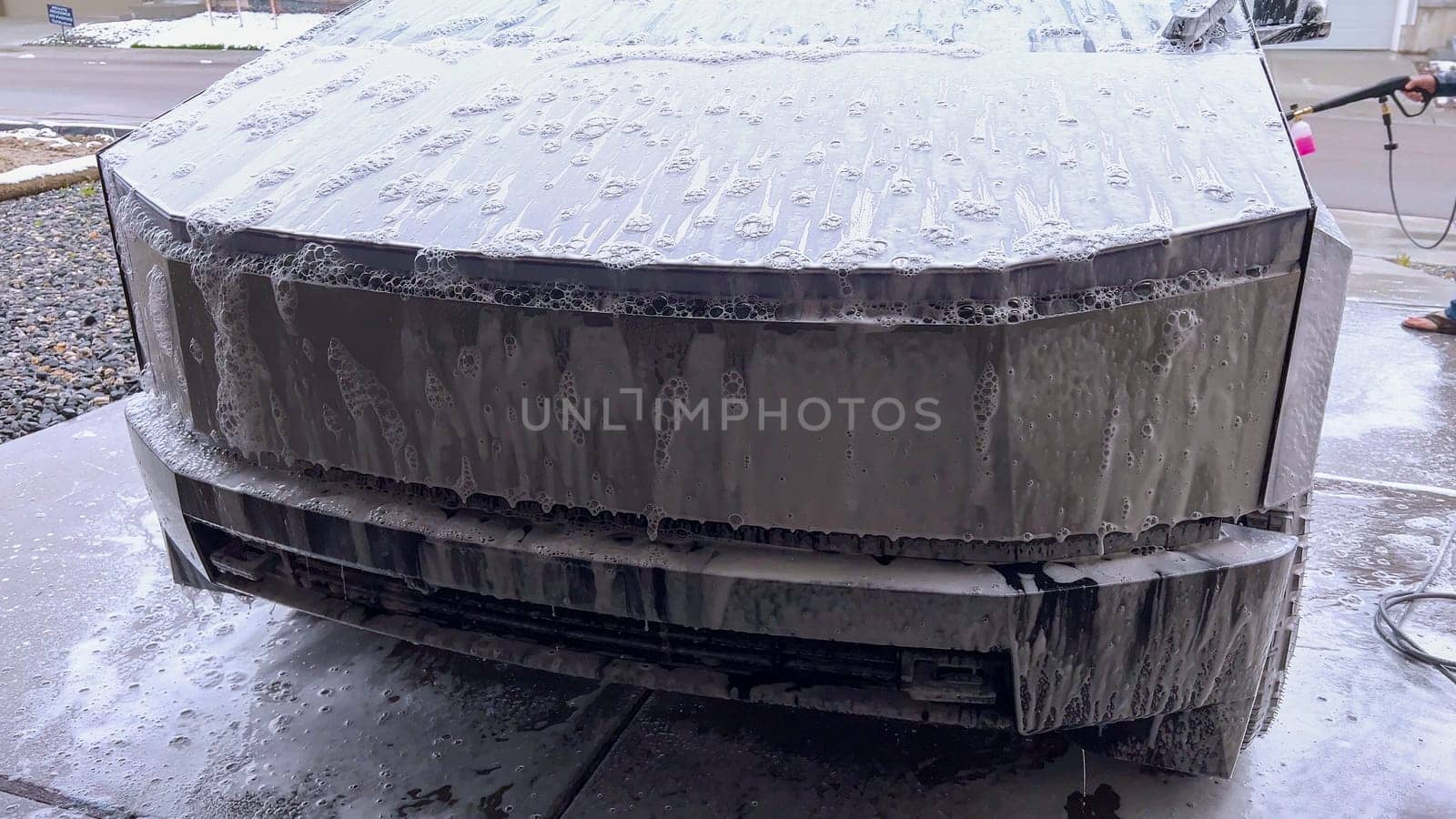 Washing a Tesla Cybertruck: Suds Covering Its Futuristic Exterior by arinahabich