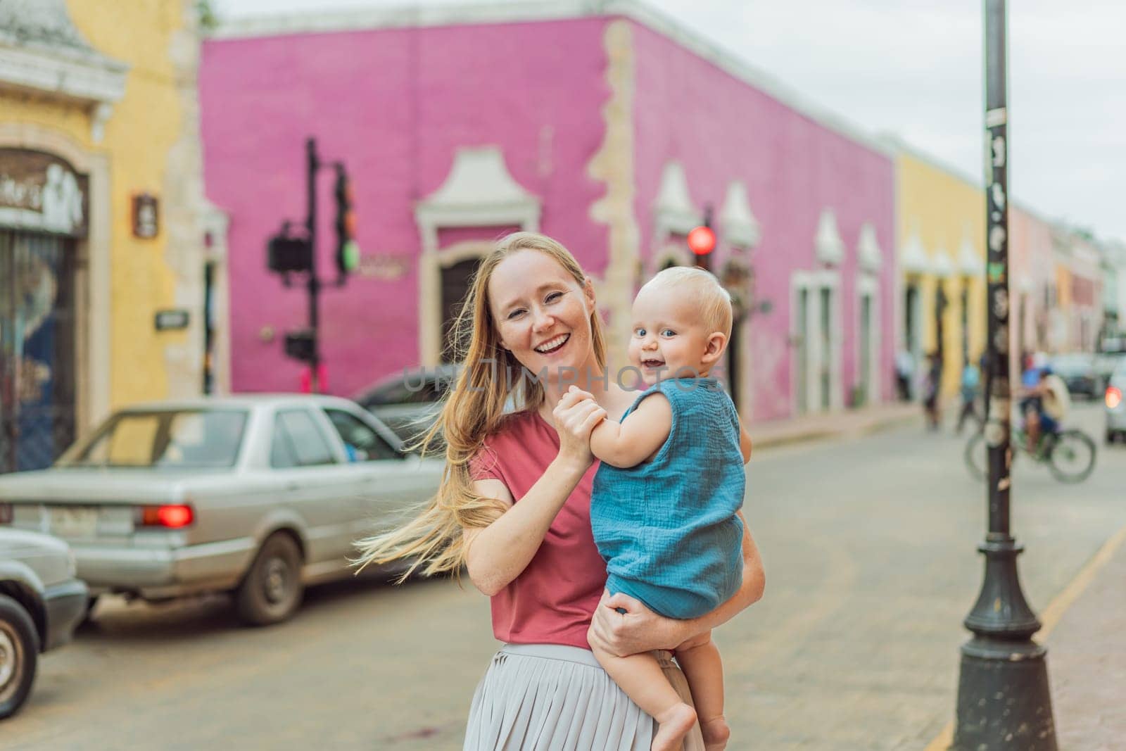 Mother and baby son tourists explore the vibrant streets of Valladolid, Mexico, immersing herself in the rich culture and colorful architecture of this charming colonial town by galitskaya
