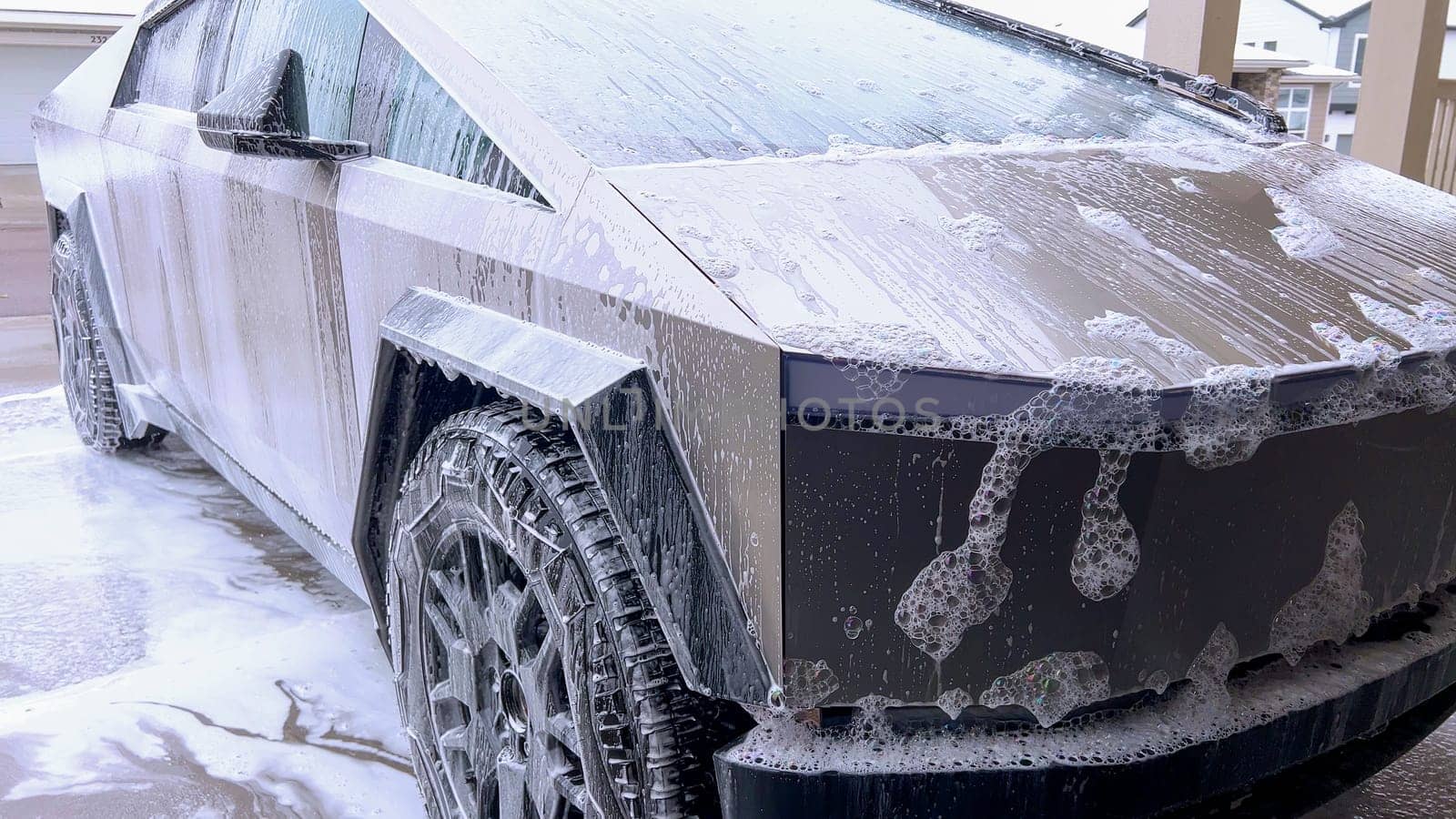 Washing a Tesla Cybertruck: Suds Covering Its Futuristic Exterior by arinahabich