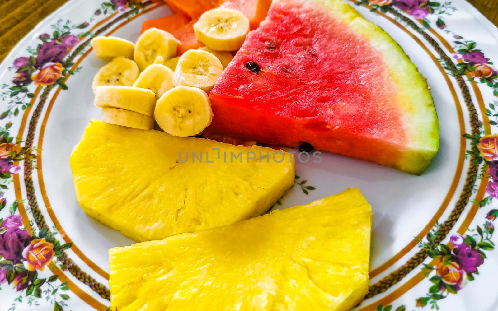 Plate with selected fruits papaya banana watermelon and pineapple in Alajuela Costa Rica in Central America.