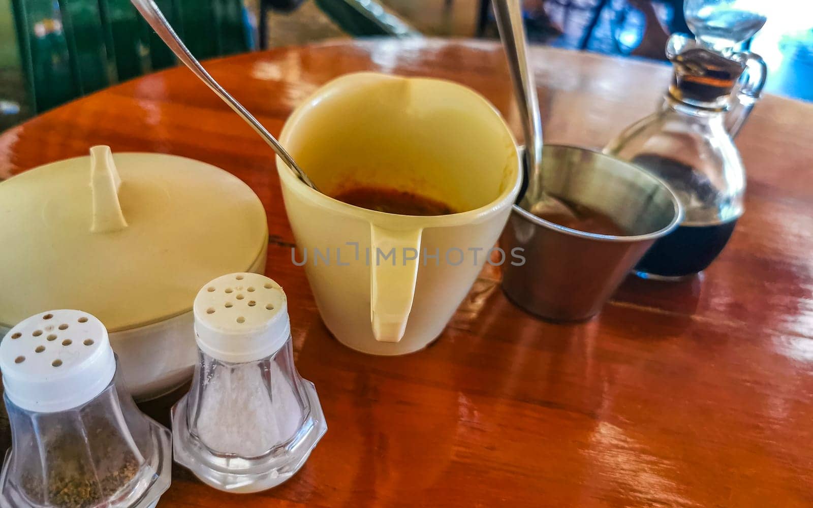 Sugar salt and pepper shaker and different sauces in restaurant in Zicatela Puerto Escondido Oaxaca Mexico.