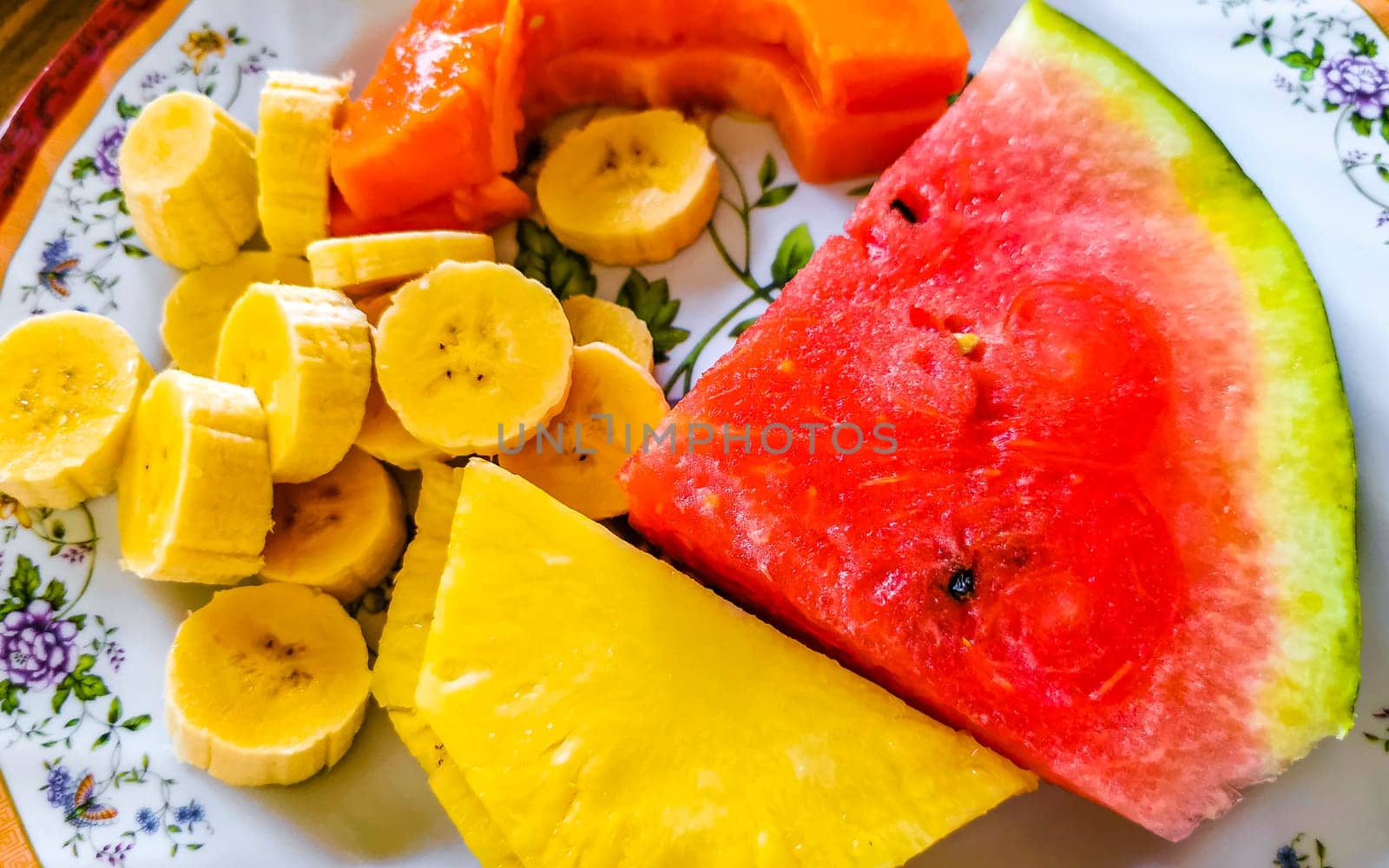 Plate with selected fruits papaya banana watermelon pineapple Costa Rica. by Arkadij