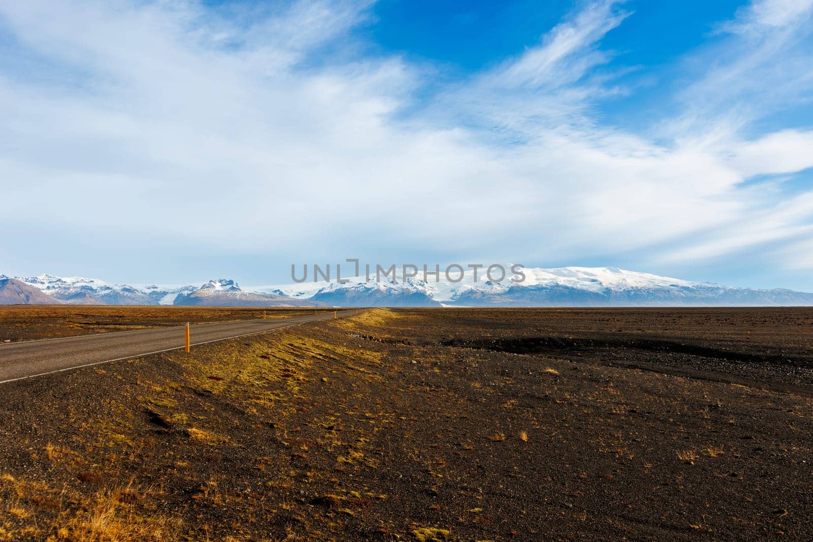 Beautiful icelandic highland scenery wuth snowy mountain peaks and bown frozen fields, scandinavian setting. Nordic landscape with hills and lands in iceland, scenic route roadside.