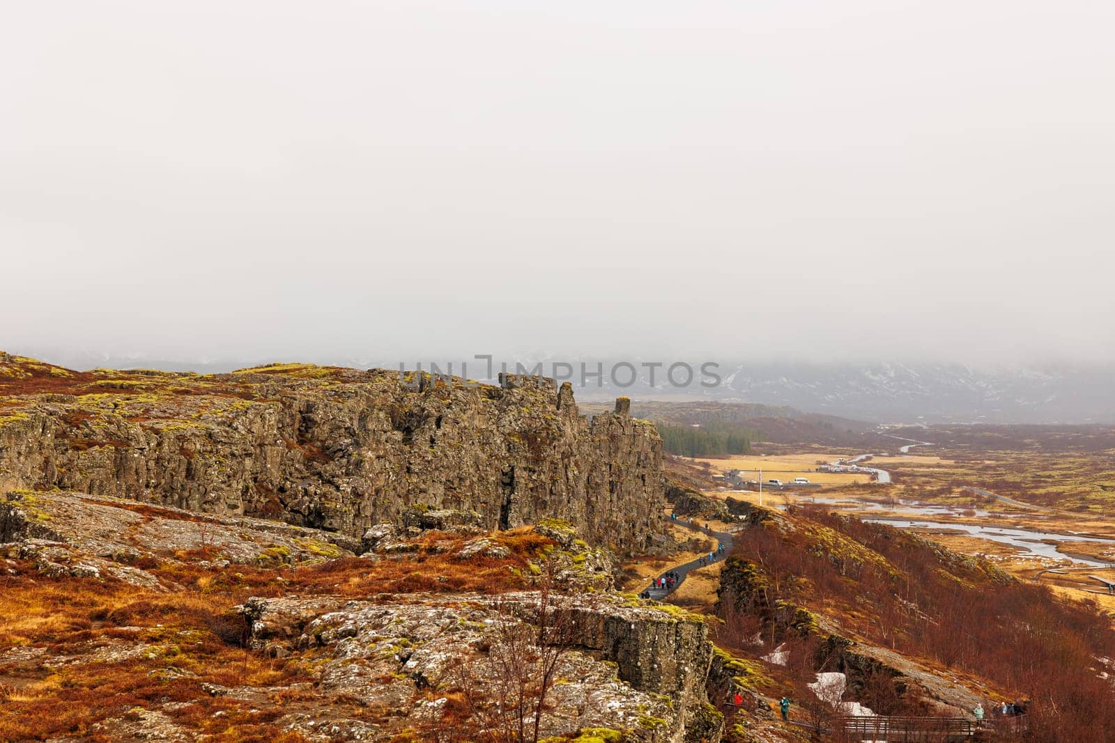 Steep highlands and river valley with rocks in Thingvellir national park, home to outstanding natural beauty. Breathtaking icelandic rocky hills and huge mountain walls, arctic scenery.