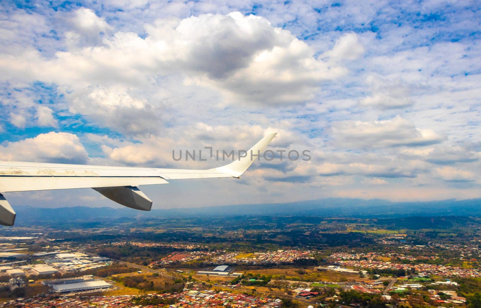 Runway airport and city mountains panorama view from airplane in Rio Segundo Alajuela Costa Rica in Central America.