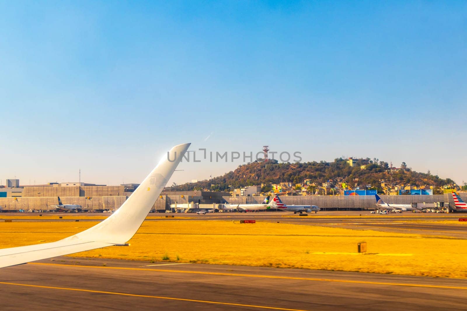 Aircraft at the airport Building and runway Mexico City Mexico. by Arkadij
