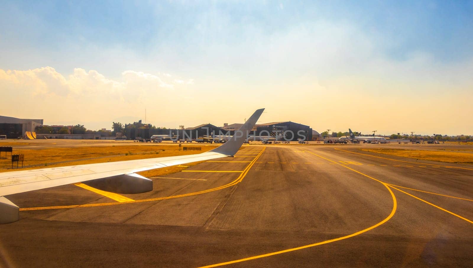 Aircraft at the airport Building and runway Aeropuerto Internacional Benito Juarez in Penon de los Banos Venustiano Carranza Mexico City Mexico.