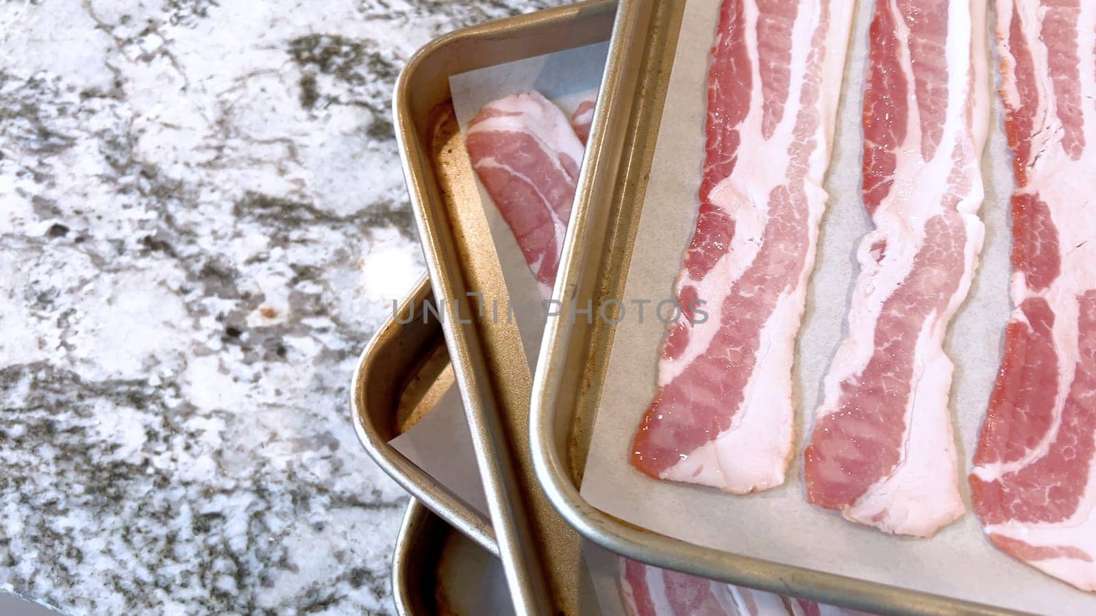 Raw Bacon Strips Ready for Cooking on a Baking Tray by arinahabich