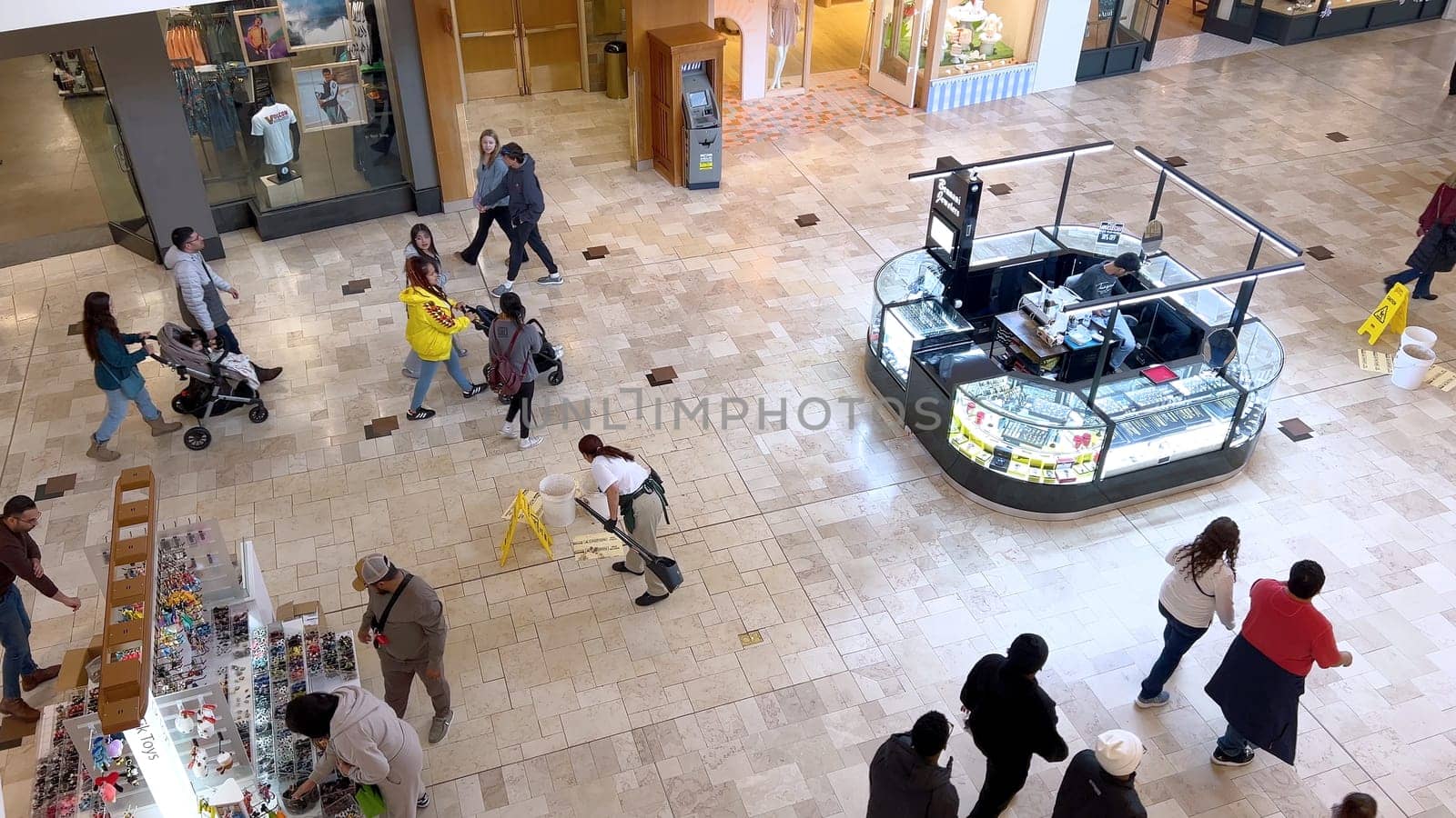 Denver, Colorado, USA-April 28, 2024- Capturing the expansive and airy interior of Park Meadows Mall, this image highlights the modern architectural style with wooden beams, large hanging lights, and a series of vibrant hanging ribbons, creating a lively shopping atmosphere.